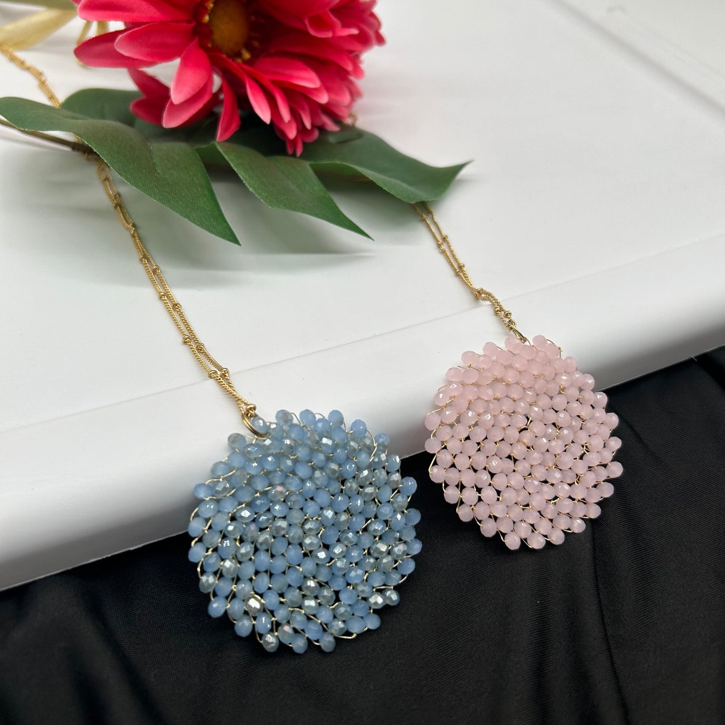 Shimmering delicate beaded circle pendant necklace, in light blue and pink. Perfect for spring!