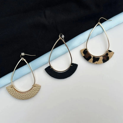 These teardrop hoop earrings come with 3 different faux leather accents to choose from. Gold, black, and leopard print