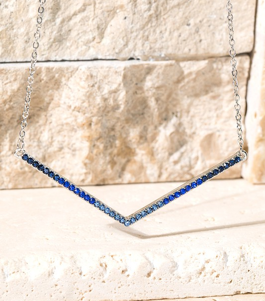 Our Chevron necklace in blue. A beautiful gradient of blue crystals start with a darker blue on the outsides, and meet with a pretty lighter blue in the middle.